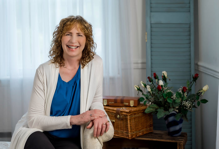 Photo of Susan R Shutt, sitting on a couch